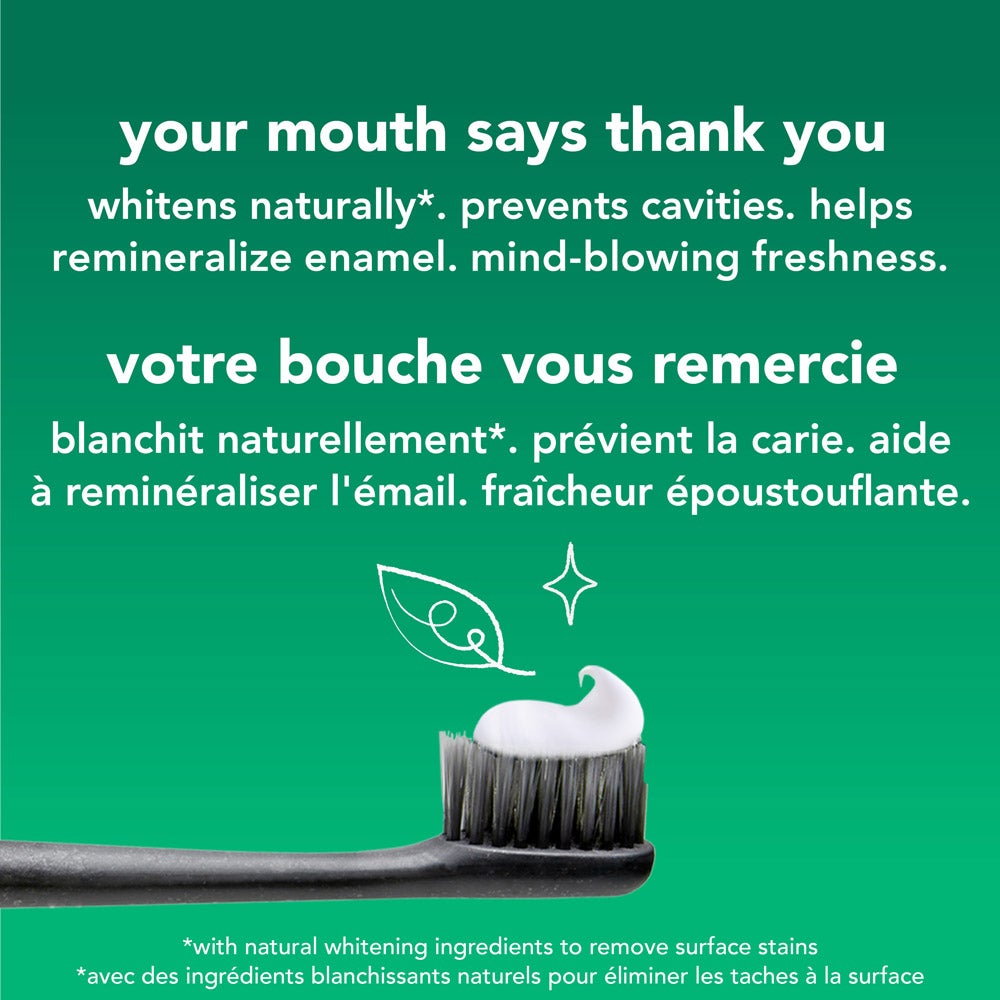 A close-up of a toothbrush with a dollop of white toothpaste, set against a green background. Above the toothbrush is a white leaf illustration. Text lists the toothpaste's benefits: &quot;whitens naturally, prevents cavities, helps remineralize enamel, mind-blowing freshness&quot; in both English and French.