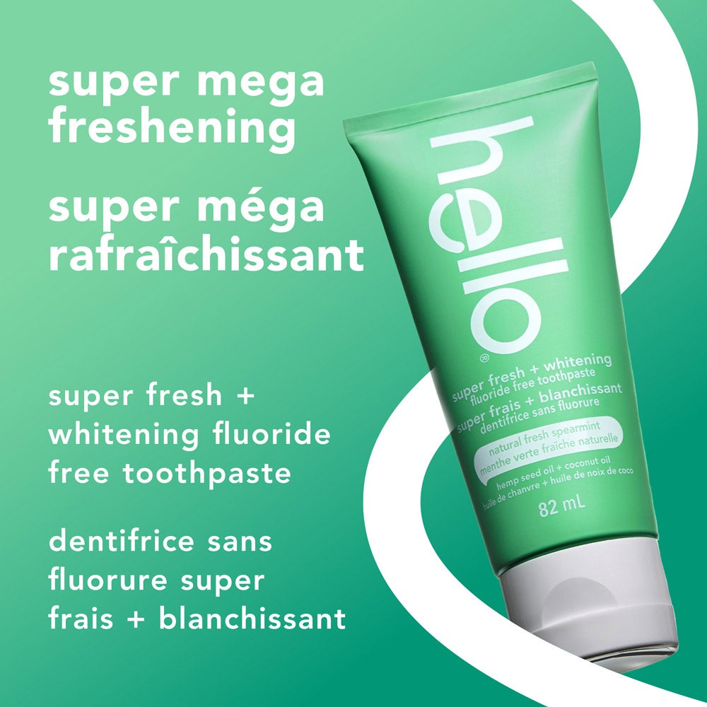A green tube of hello super fresh + whitening fluoride free toothpaste is angled on a light green background. Above the tube, the text reads, &quot;super mega freshening.&quot; To the left, smaller text says, &quot;super fresh + whitening fluoride free toothpaste.&quot;