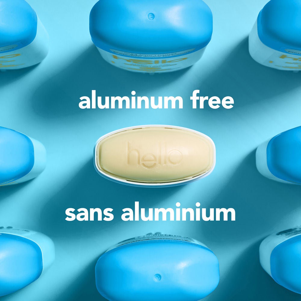 Overhead view looking directly down at the open solid deodorant stick revealing the oval product head. Centered text prominently states "aluminum free" in English and "sans aluminium" in French.  