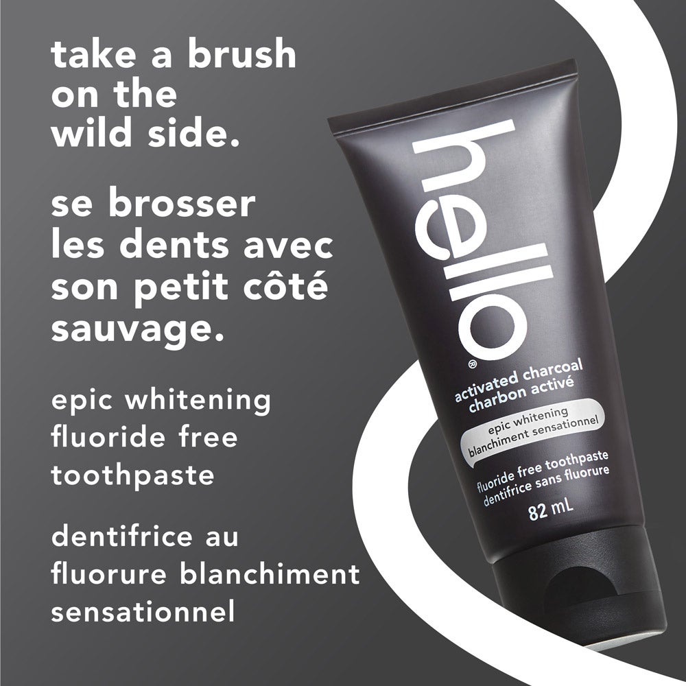 A tube of hello epic fluoride free charcoal toothpaste is displayed at an angle on a gray background with a white circular accent. Text beside the tube reads: &quot;take a brush on the wild side&quot; and its French translation, along with the product name in both English and French.