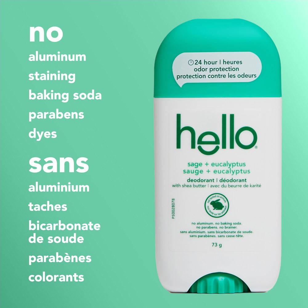 A close-up of a hello Sage + Eucalyptus deodorant stick with a green cap, standing upright on a green background. The image features text listing product attributes: &quot;no aluminum, staining, baking soda, parabens, dyes.&quot;
