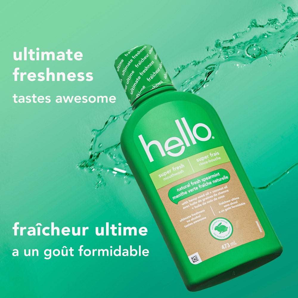 A green hello super fresh mouthwash bottle is displayed in front of a splash of water on a teal gradient background. Text says, &quot;ultimate freshness – tastes awesome&quot; in English and French translation below.