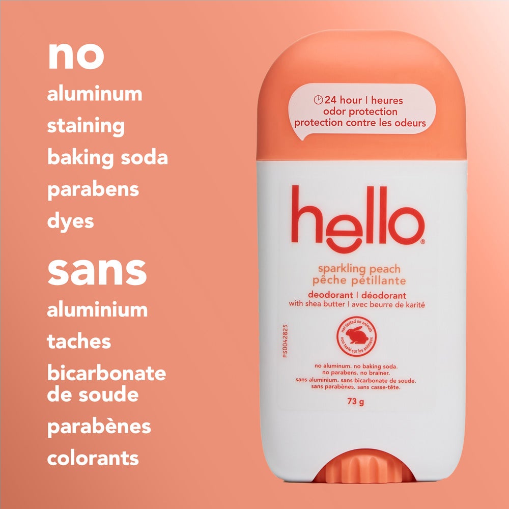 A close-up of a hello sparkling peach deodorant stick standing upright on a peach background. The image highlights text stating &quot;no aluminum, staining, baking soda, parabens, dyes.