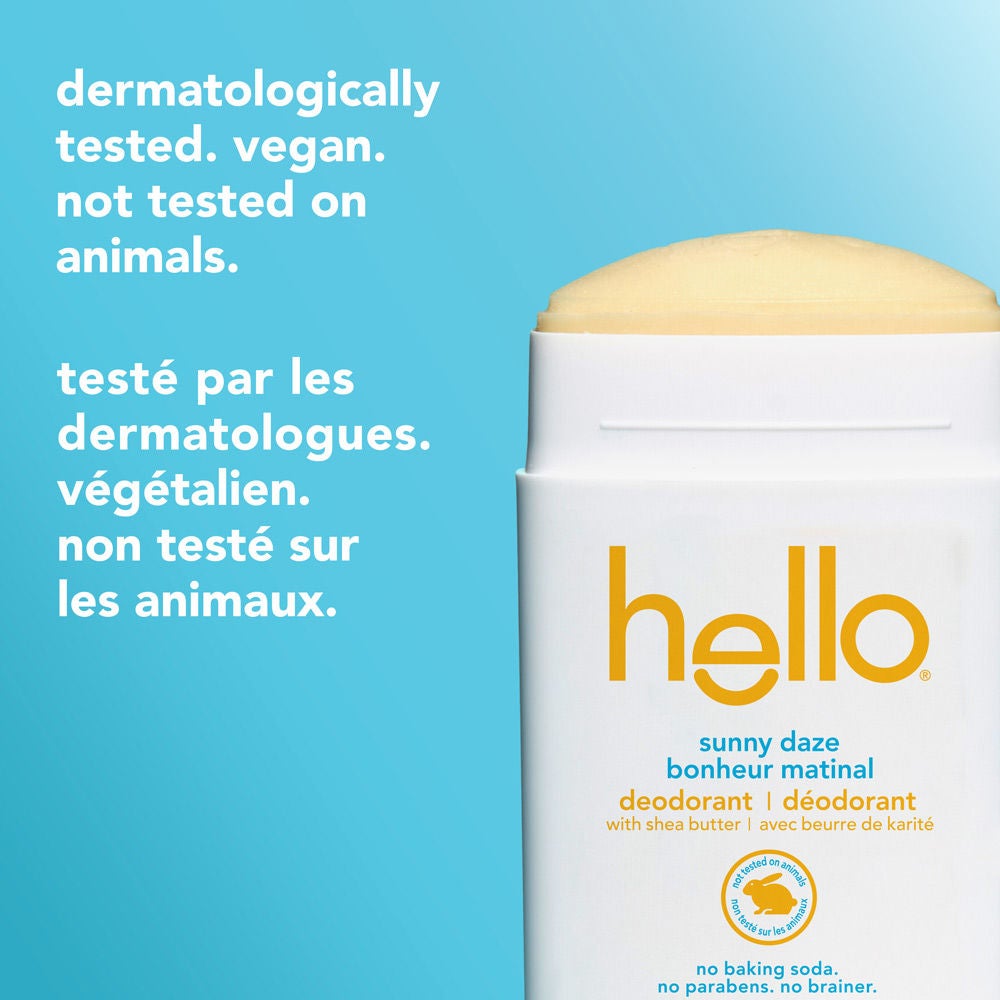 Close-up of the open Hello Sunny Daze deodorant stick with cream-colored solid stick exposed. Side text states "dermatologically tested. vegan. not tested on animals." with matching French translation below.