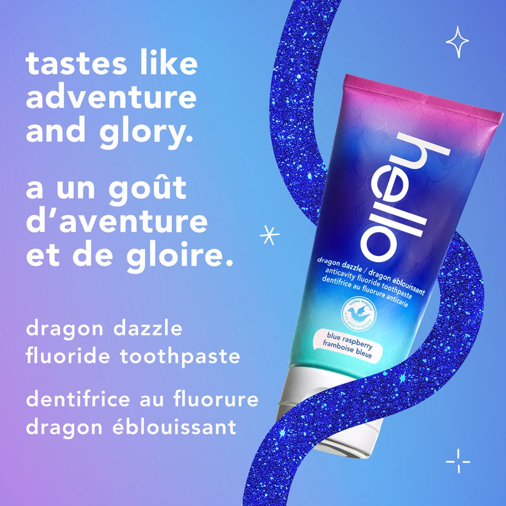 A tube of hello dragon dazzle blue raspberry fluoride toothpaste is displayed on a sparkly blue curved border with a light blue background. The text reads, &quot;tastes like adventure and glory. dragon dazzle fluoride toothpaste.&quot;