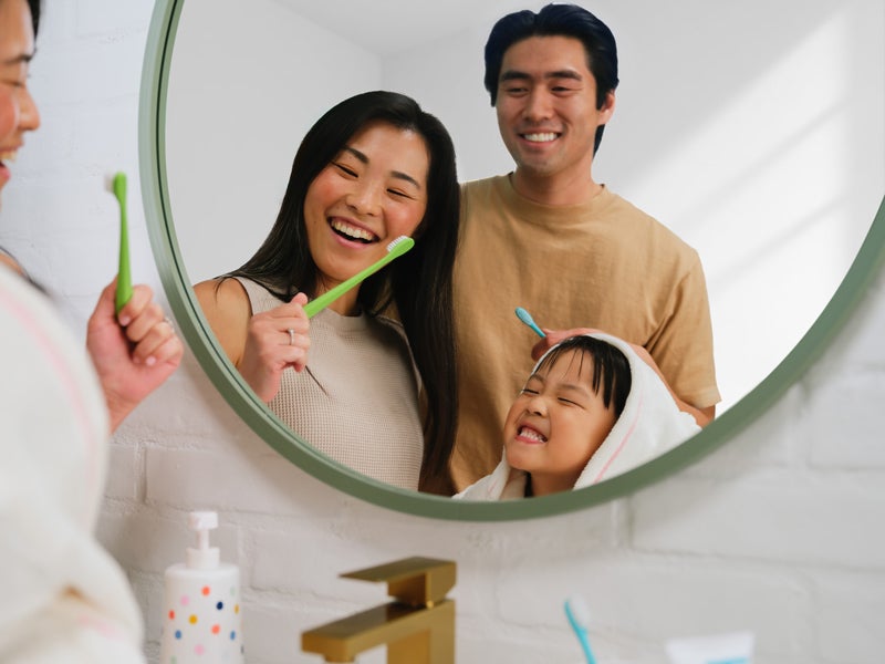 Family smiling in a mirror